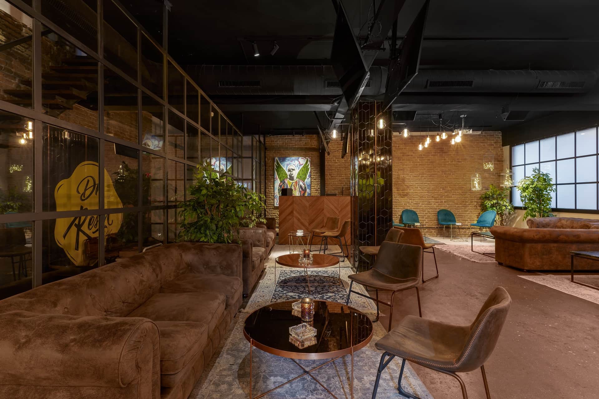 Dr. Resin Barcellona club sociale della cannabis — ampia lounge con divani marroni, tavolini e interno di design